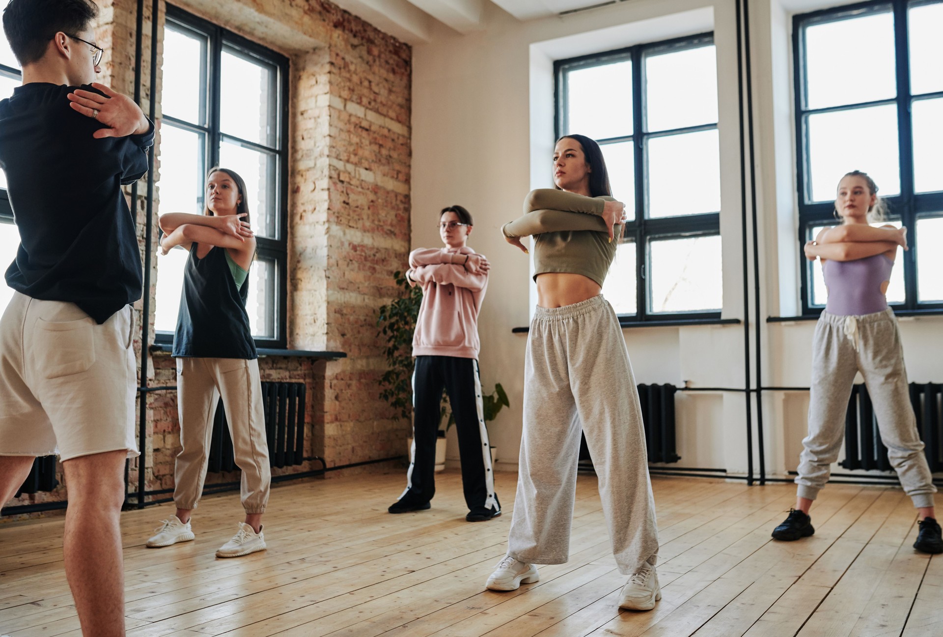 Contemporary teens standing in front of vogue dancing instructor during training